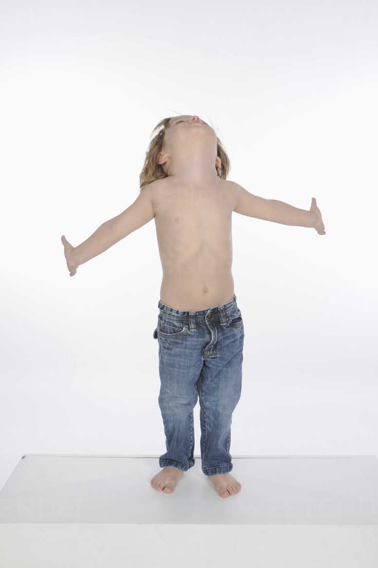 Little boy (2-3) with bare chest, arms out, portrait stock photo