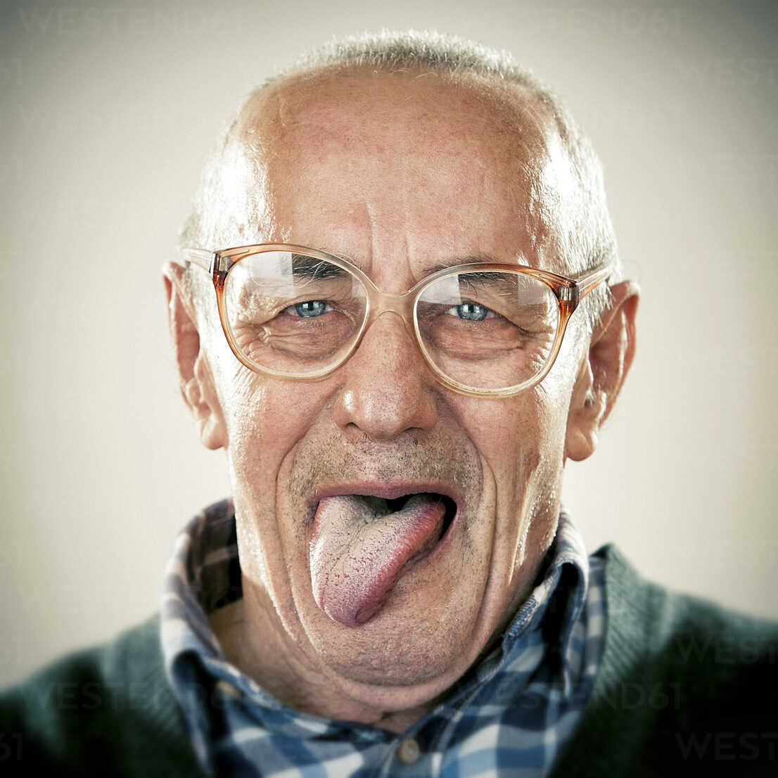 Portrait Of An Elderly Man Sticking His Tongue Out ZOCF00175 