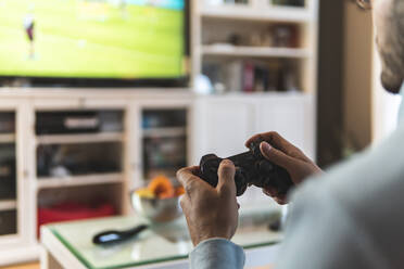 Man disappointed while playing video game with girlfriend at home stock  photo