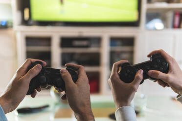 Man disappointed while playing video game with girlfriend at home stock  photo